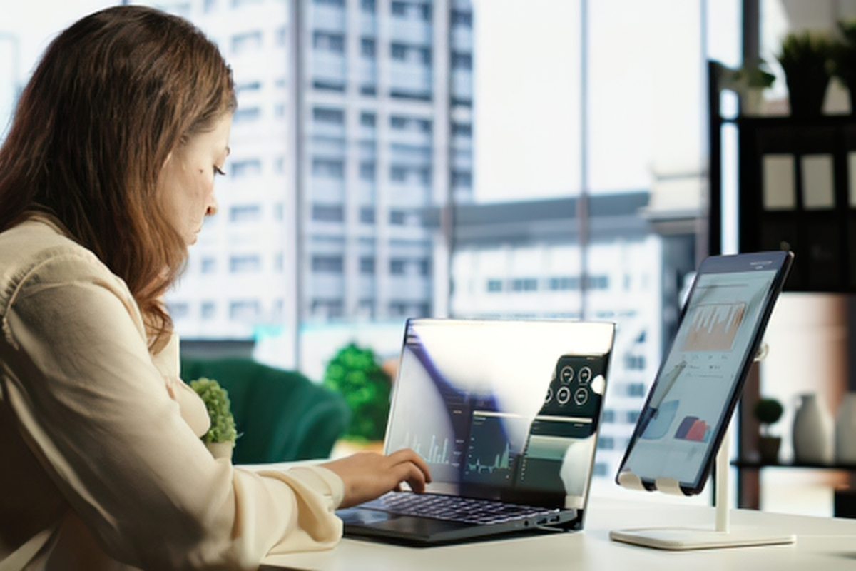 Profissional trabalhando em múltiplos monitores na gestão de campanhas de e-mail marketing